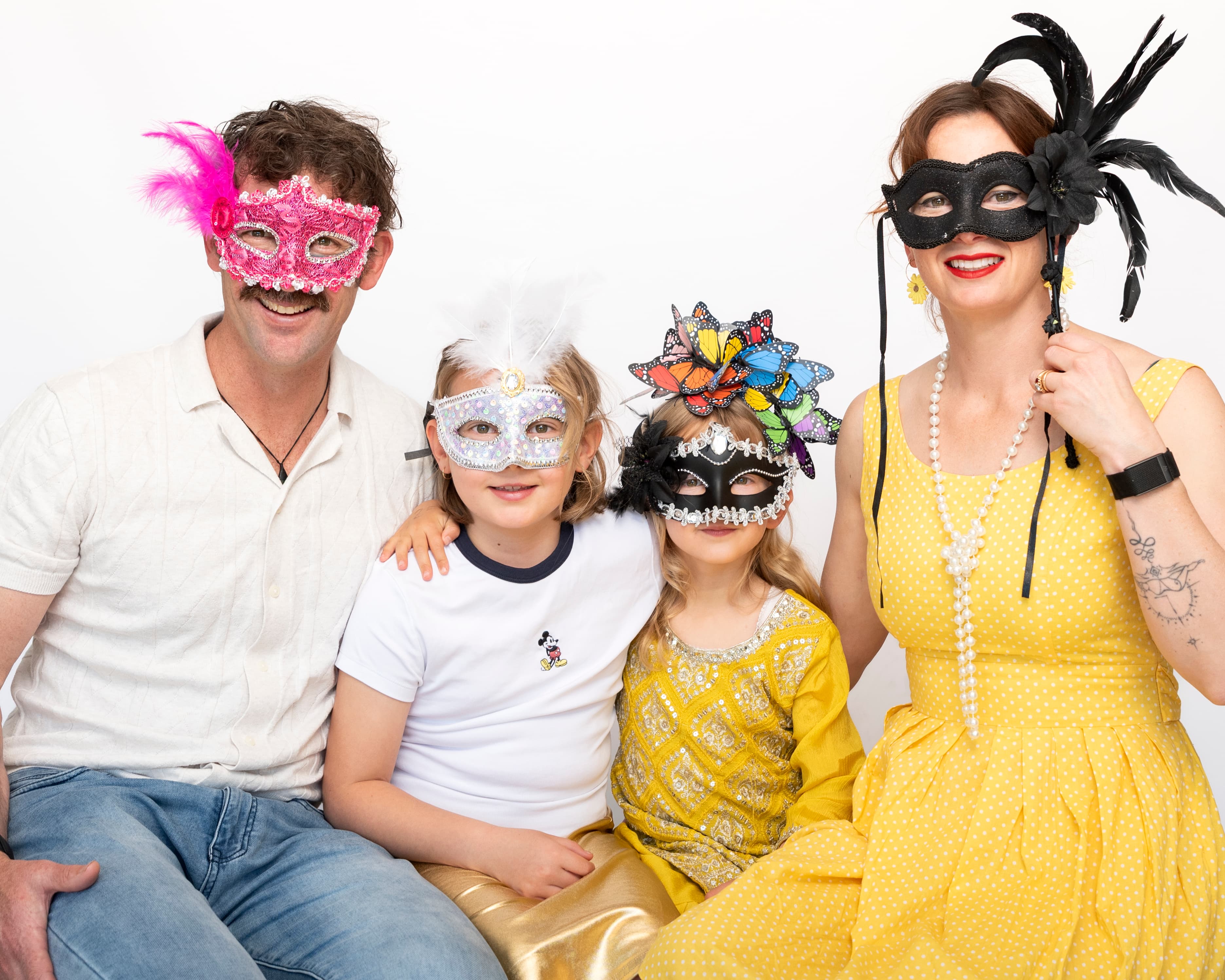 Steffanie with family wearing masquerade masks