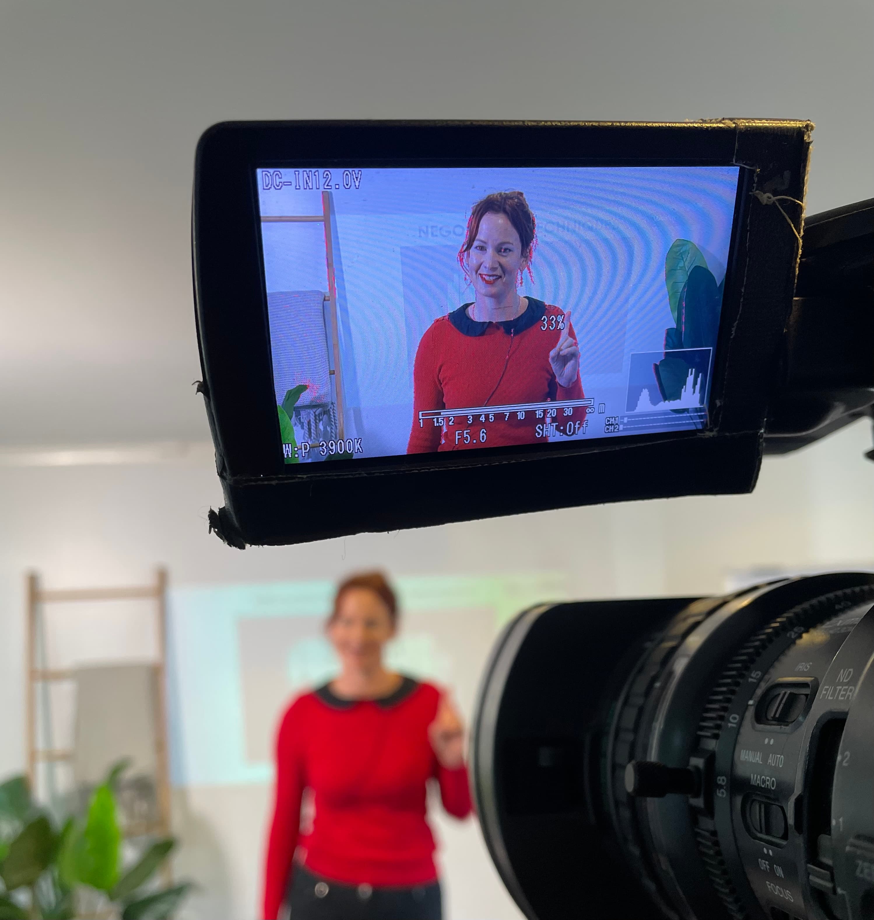 Steffanie being filmed through a camera viewfinder