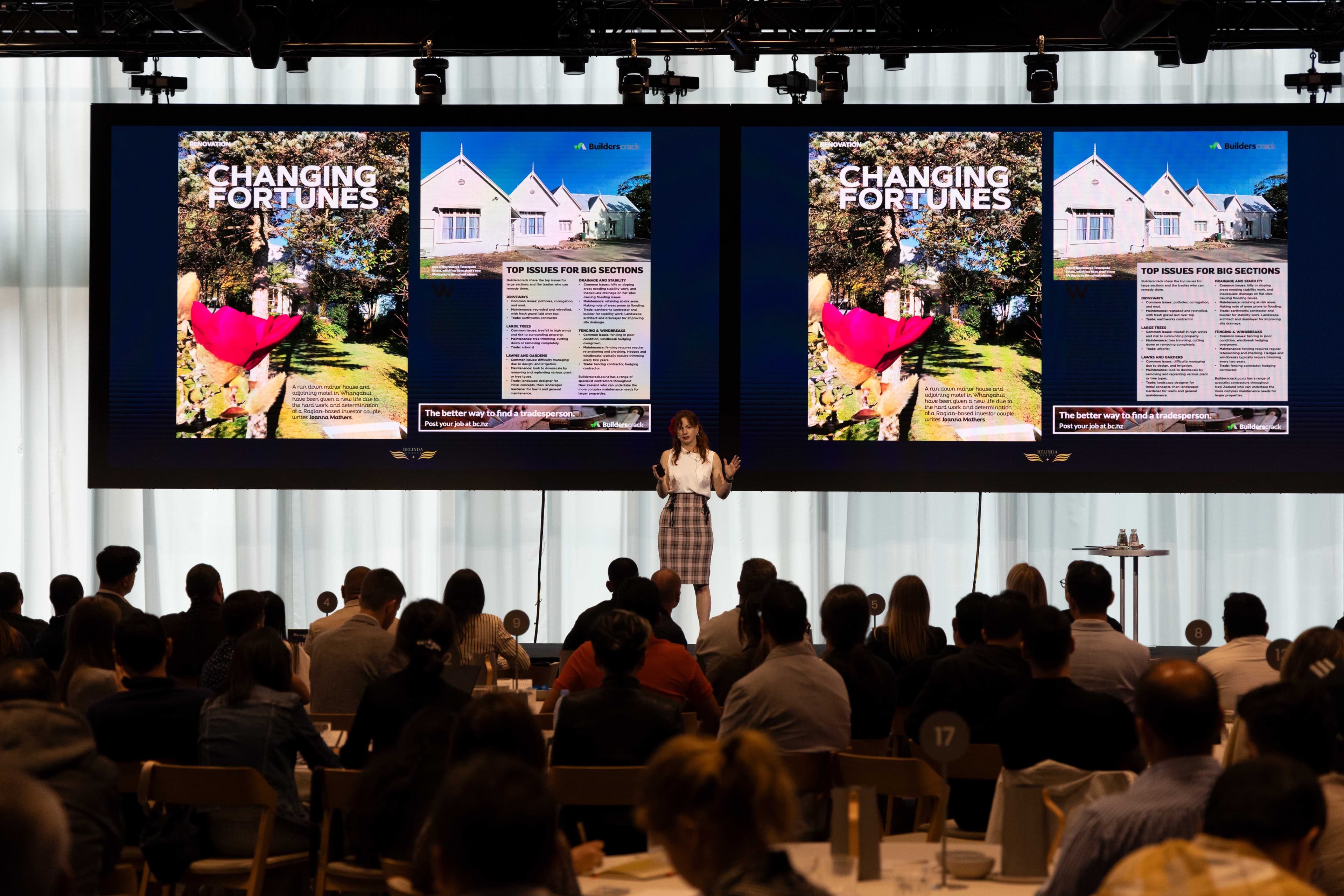Steffanie presenting on stage to a large audience
