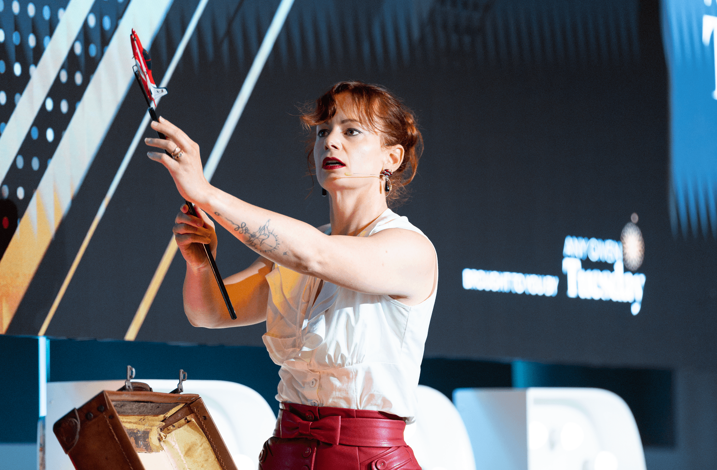 Steffanie on stage with a prop during a keynote